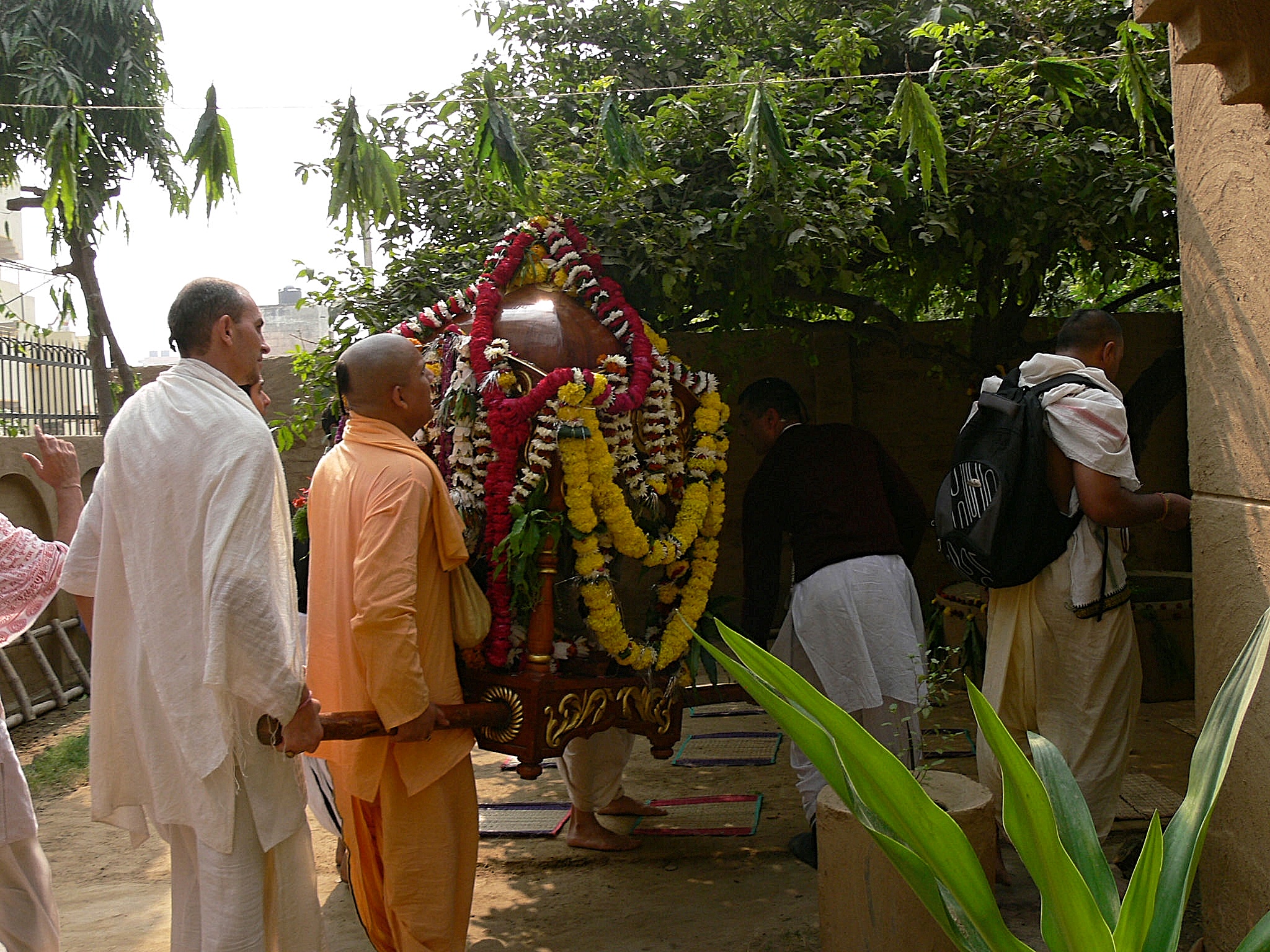 Radha Madhava arriving at a courtyard festival